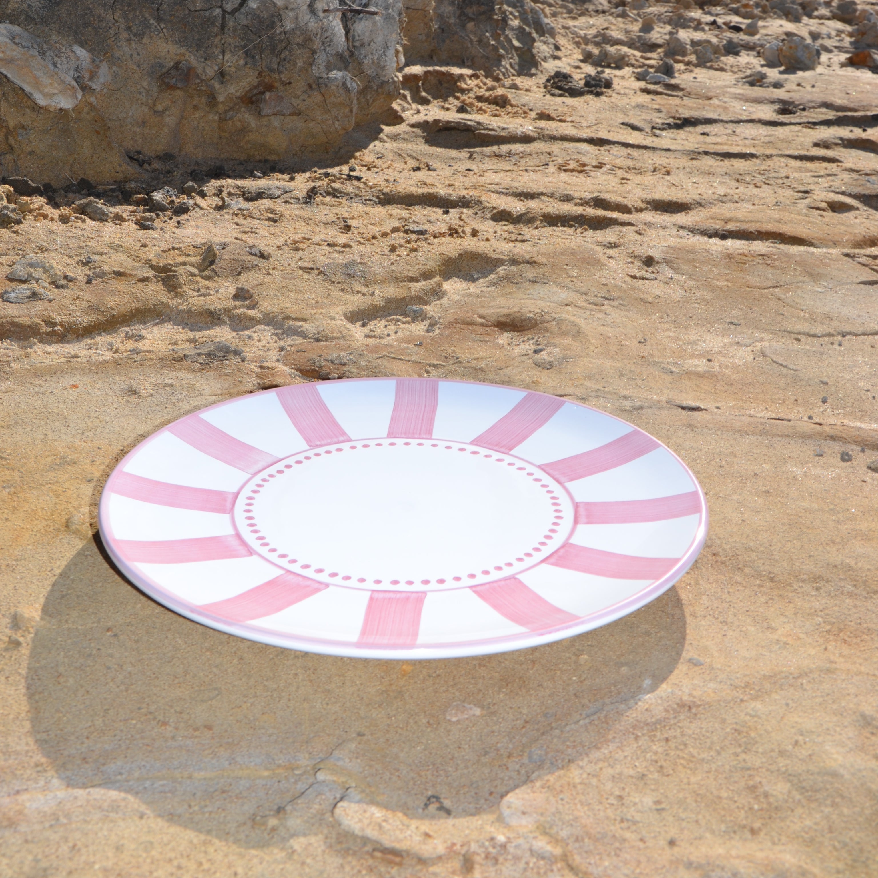 Pink and white target on a rocky surface