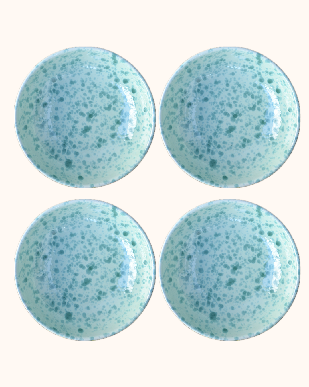 Four blue speckled round objects on a white background