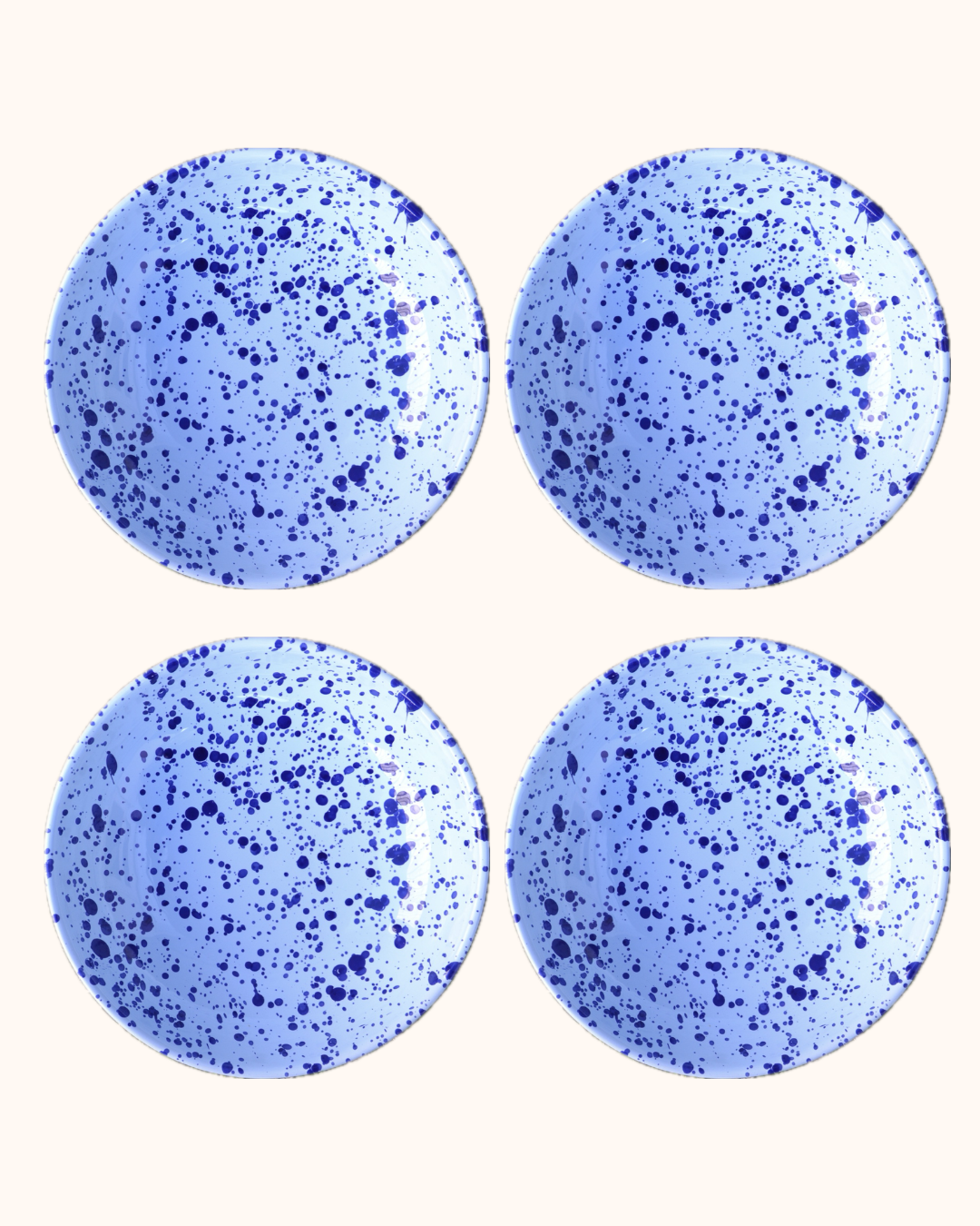 Four blue speckled round objects on a white background